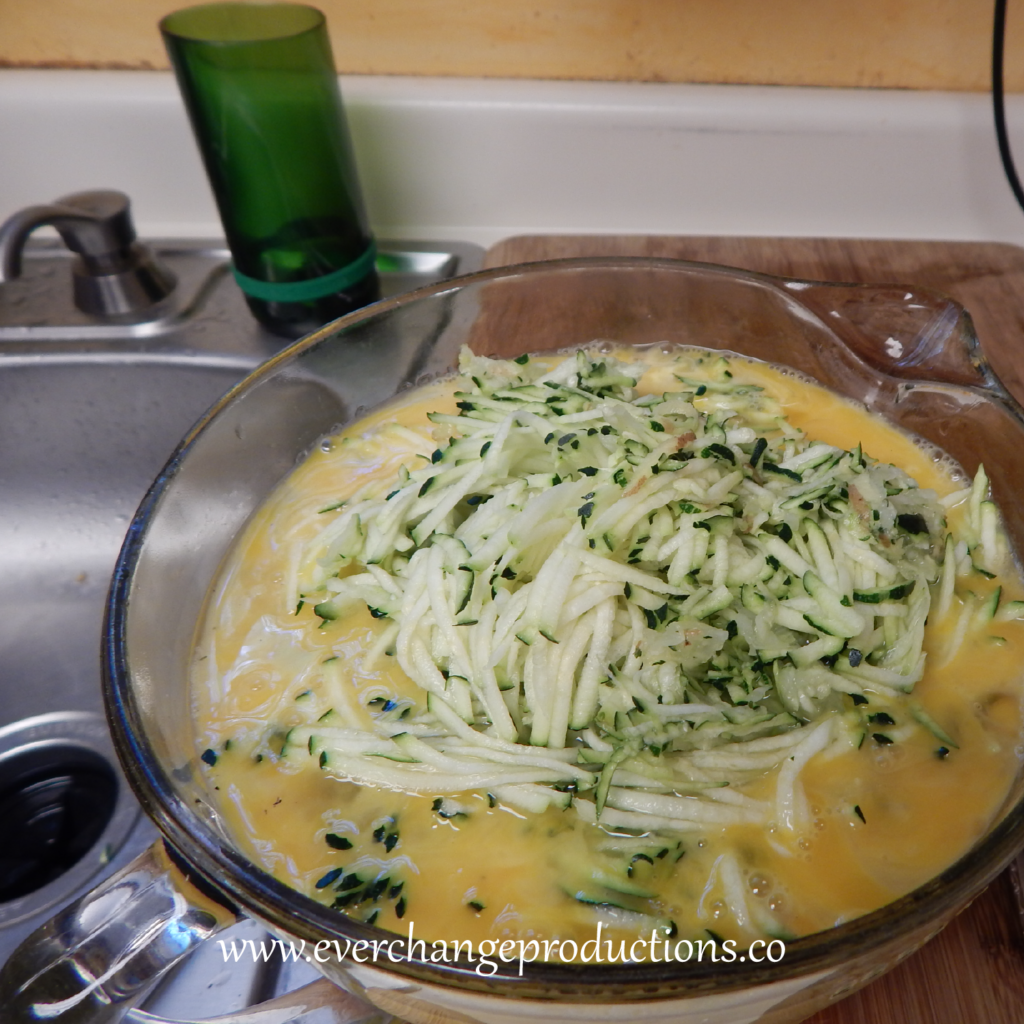 Step Three of my favorite local recipe: mix shredded zucchini, onion, garlic, bacon and 2 cups of cheese.