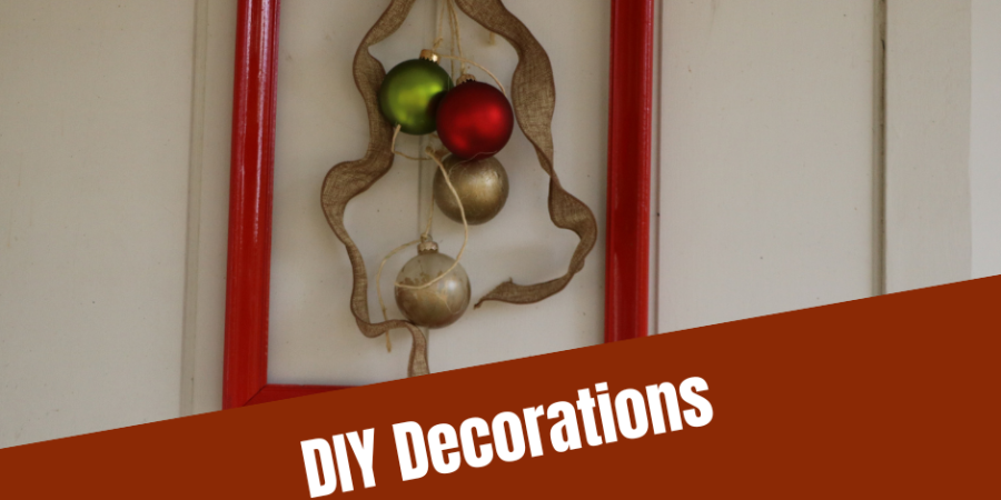 Red picture frame with Christmas ornaments hanging in the middle with the caption "DIY Decorations: Picture Perfect Wreath"