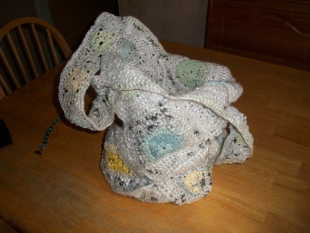 My inspiration to learn how to make plarn (plastic yarn) and crochet is this bag my grandmother gave me.