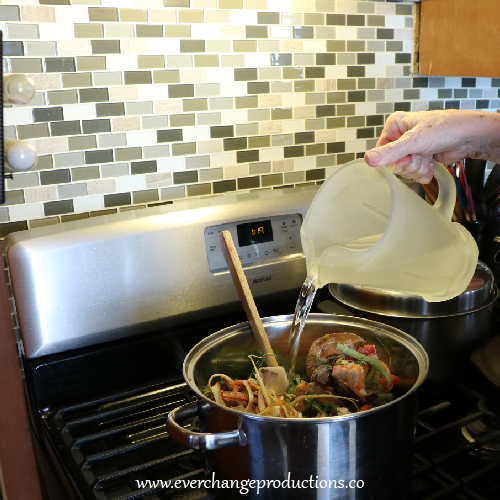 Add the water, frozen vegetable scraps, bay leaves, parsley, and thyme. Reduce heat to low and simmer, partially covered, for 45 minutes.