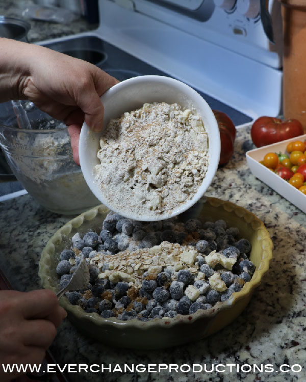 Work together with your hands until chunky. Pour over top of fruit.