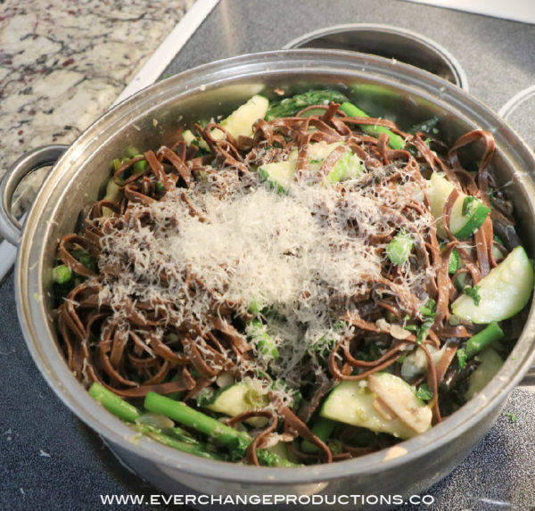 Toss vegetables in noodles, add basil and grate Parmesan cheese on top.