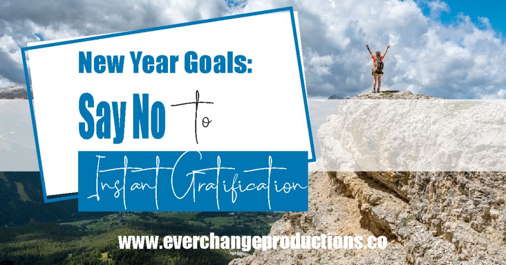 accomplished person on top of mountain with words that say New Year Goals: Say No to Instant Gratification